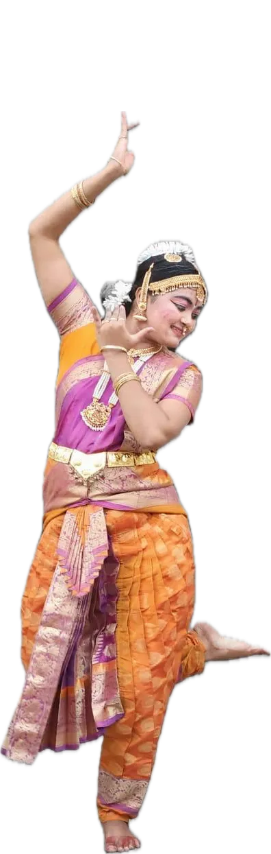 Binni Patel in Bharatanatyam costume and temple jewellery, one arm raised in a hasta, mid-movement.