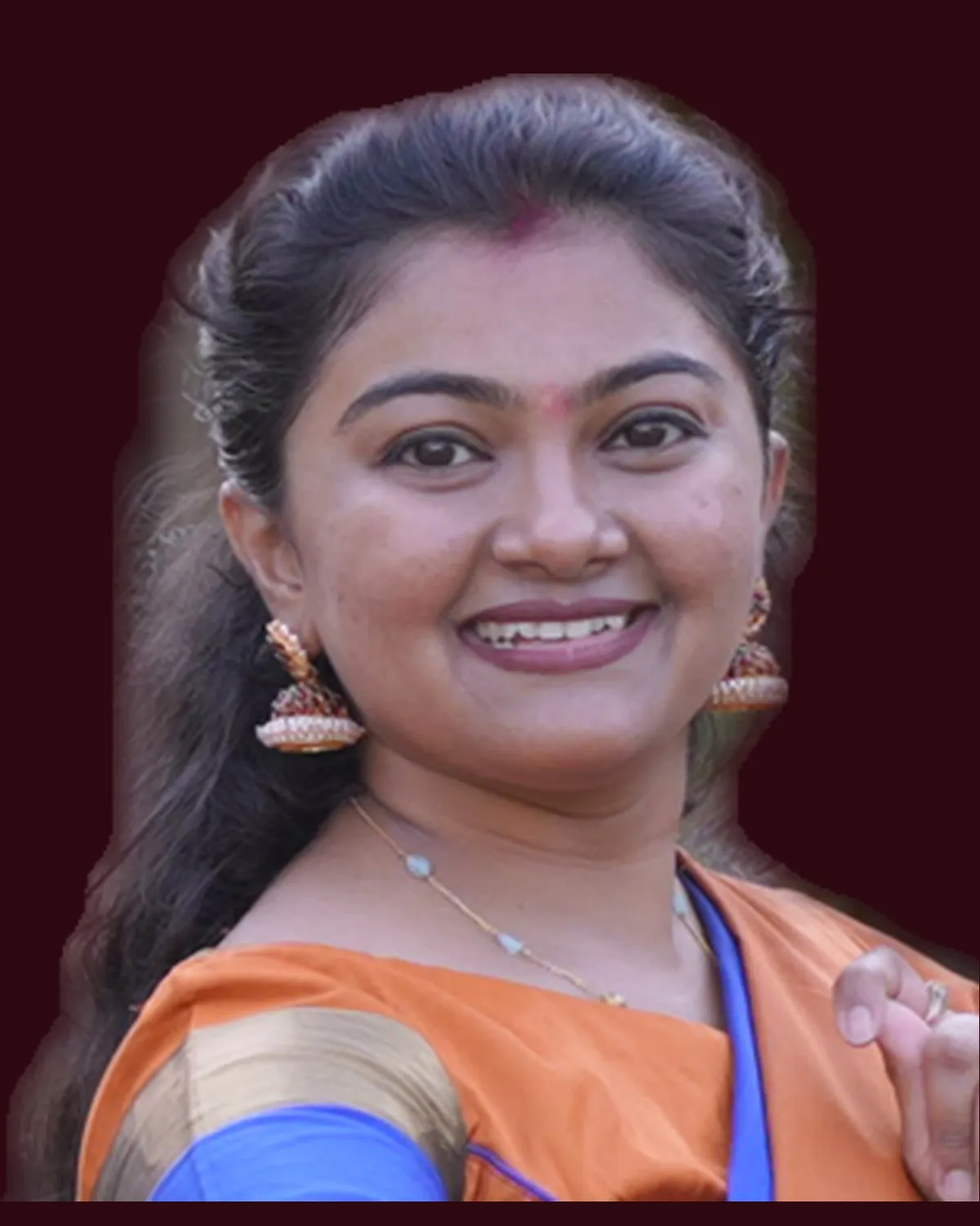 Binni Patel, warm and direct, looking straight at the camera.